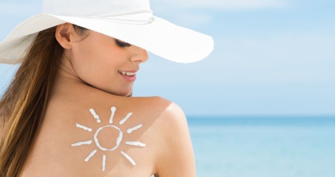 Sun Drawn On Woman's Shoulder With Sun Protection Cream